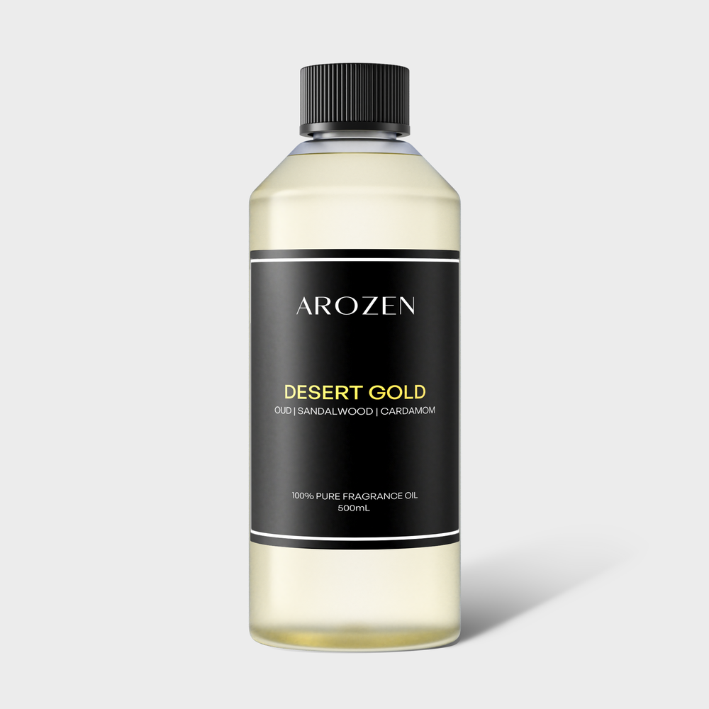 
                  
                    A 500ml clear bottle of DESERT GOLD fragrance oil features rich oud wood, sandalwood, and cardamom notes. Designed for electric diffusers, it has a black cap and a sleek black label with gold and white text.
                  
                