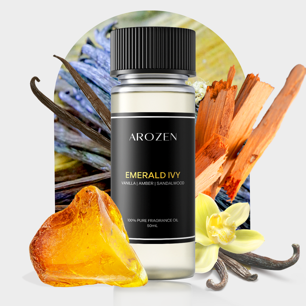 A bottle of Arozen EMERALD IVY is displayed with vanilla beans, sandalwood sticks, amber resin, and a vanilla flower, set against a light background featuring a botanical arch design.