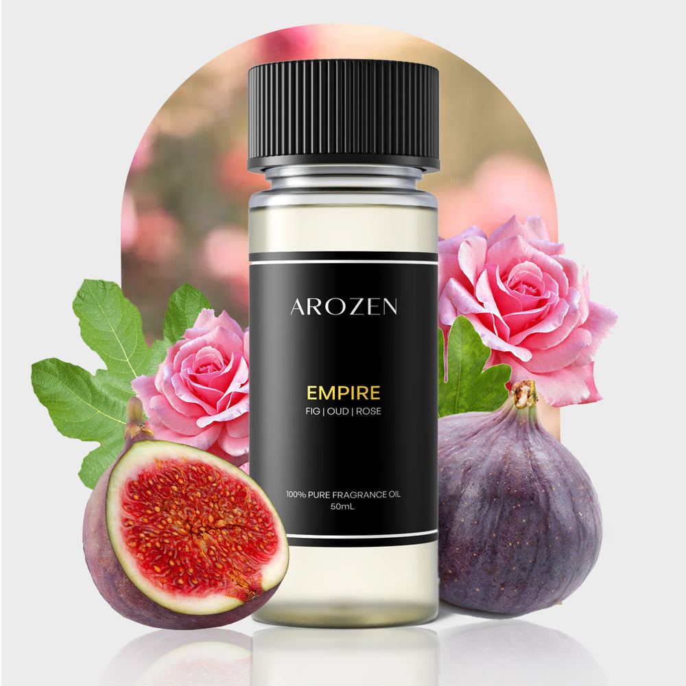 A bottle of Arozen EMPIRE, labeled FIG | OUD | ROSE, sits among fresh figs, fig leaves, and pink roses against a soft floral background.