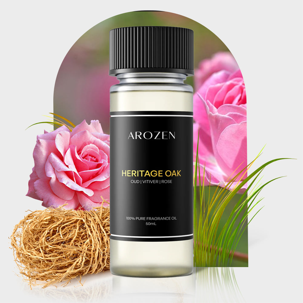 A bottle of Arozen HERITAGE OAK Fragrance Oil sits before pink roses and vetiver roots, emphasizing its oud, vetiver, and rose scent notes.