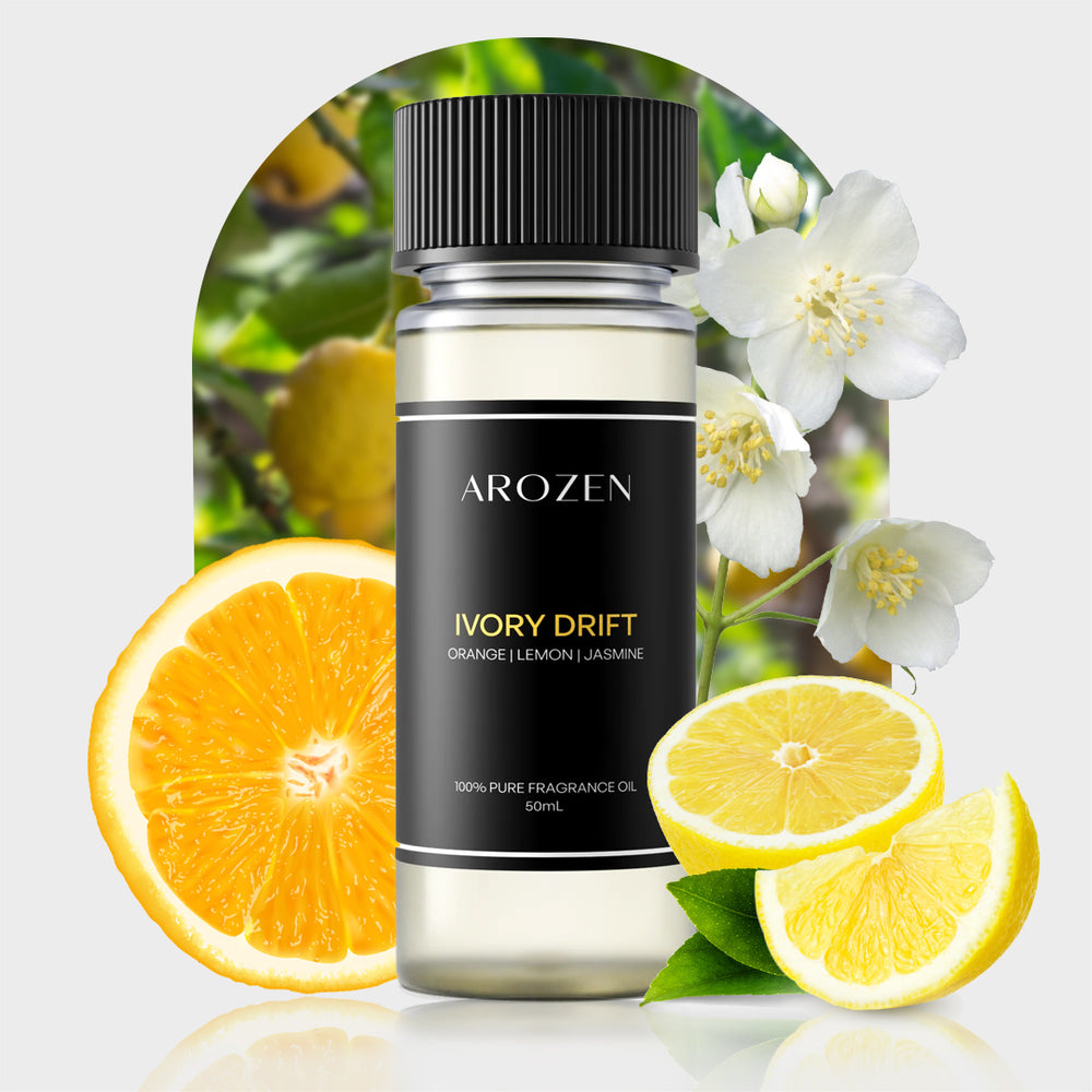 A bottle of Arozen IVORY DRIFT is displayed with orange and lemon slices, jasmine flowers, and green leaves, showcasing its vibrant citrus and jasmine fragrance notes.