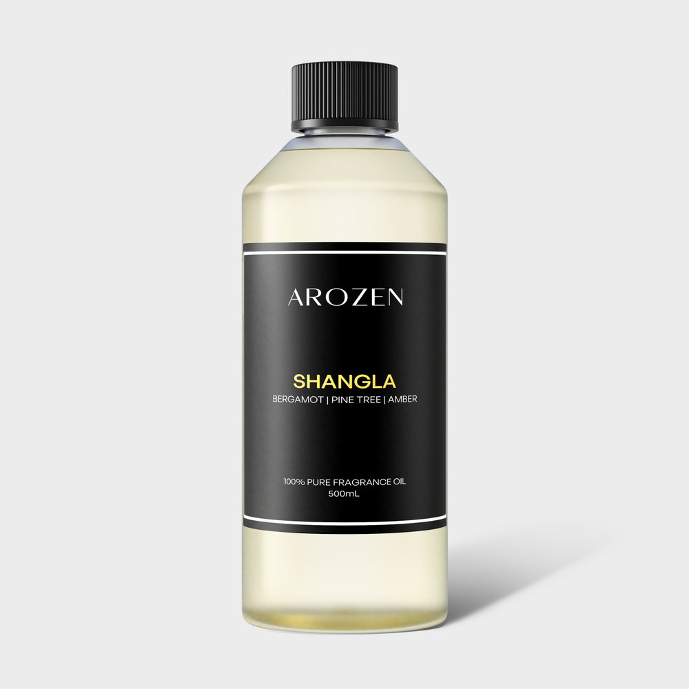 
                  
                    A 500ml clear plastic bottle with a black cap labeled Arozen SHANGLA, featuring fragrance notes of bergamot, pine tree, and amber on a black background.
                  
                