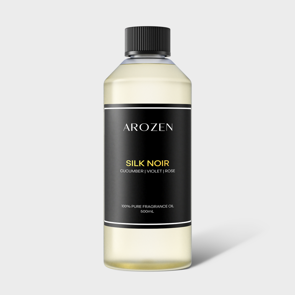 
                  
                    A clear plastic bottle with a black screw cap, labeled SILK NOIR pure fragrance oil, 500ml, features notes of cucumber, violet, and rose—an electric scent diffuser oil inspired by Hilton Hotels on a black and gold label.
                  
                