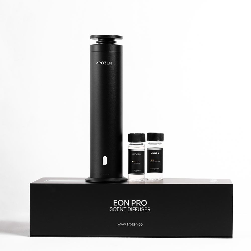 
                  
                    The Arozen EON PRO SCENT DIFFUSER, a sleek black electric scent diffuser, stands upright on its box with two small fragrance oil bottles beside it, set against a clean white background.
                  
                